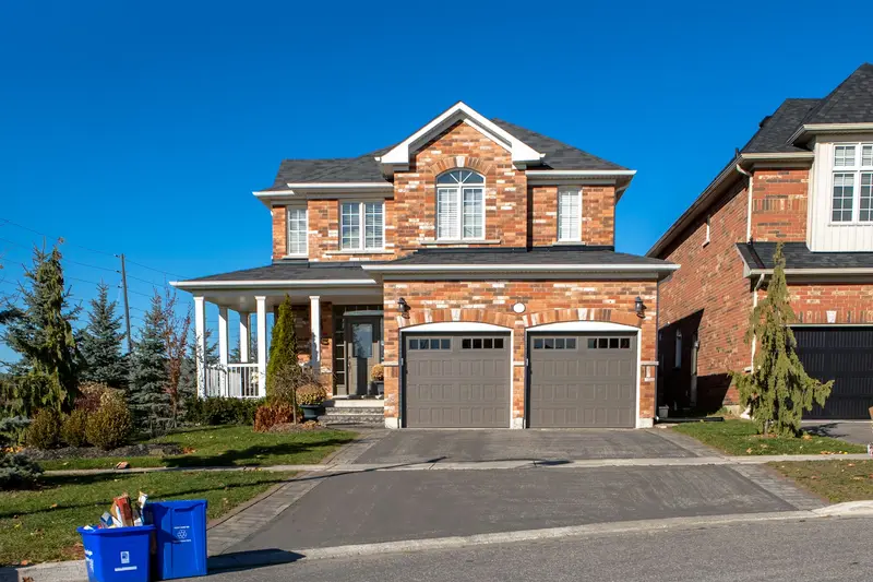 Brick two story house with a two door attached garage